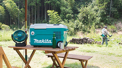A Makita 18V X2 LXT Cooler/Warmer sits on a picnic table.