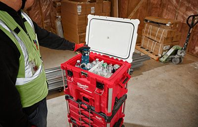 A drink is pulled out of the Milwaukee PACKOUT 40QT XL Cooler.