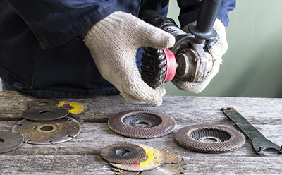 A wire wheel is changed out on an angle grinder.