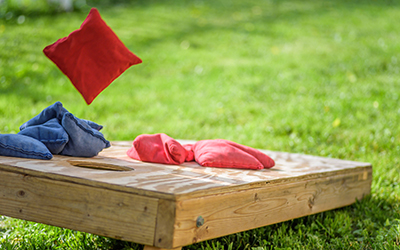 A bag is tossed during a game of cornhole.