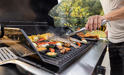 Fish is flipped on a grill.