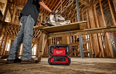 A Milwaukee CARRY-ON Power Supply powers a table saw on a jobsite.