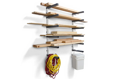 Scrap lumber, extension cords, and a bucket hang on a Bora Portamate Wall Mounted Storage Rack.