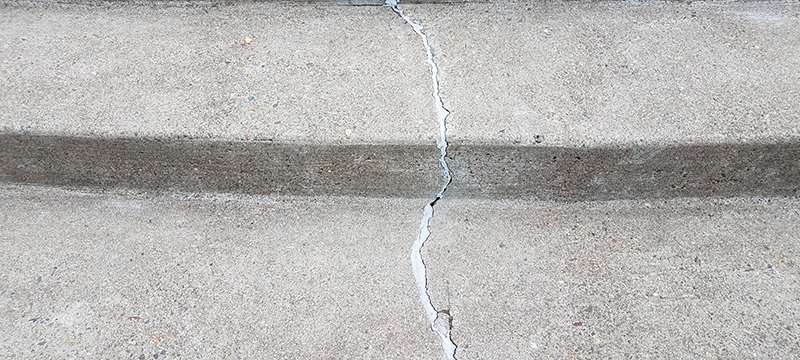 A crack repaired with caulk on a flight of stairs.