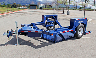 An Air-Tow drop deck trailer sits in a parking lot.