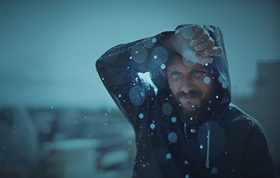 A man wearing rain gear during a rain storm.