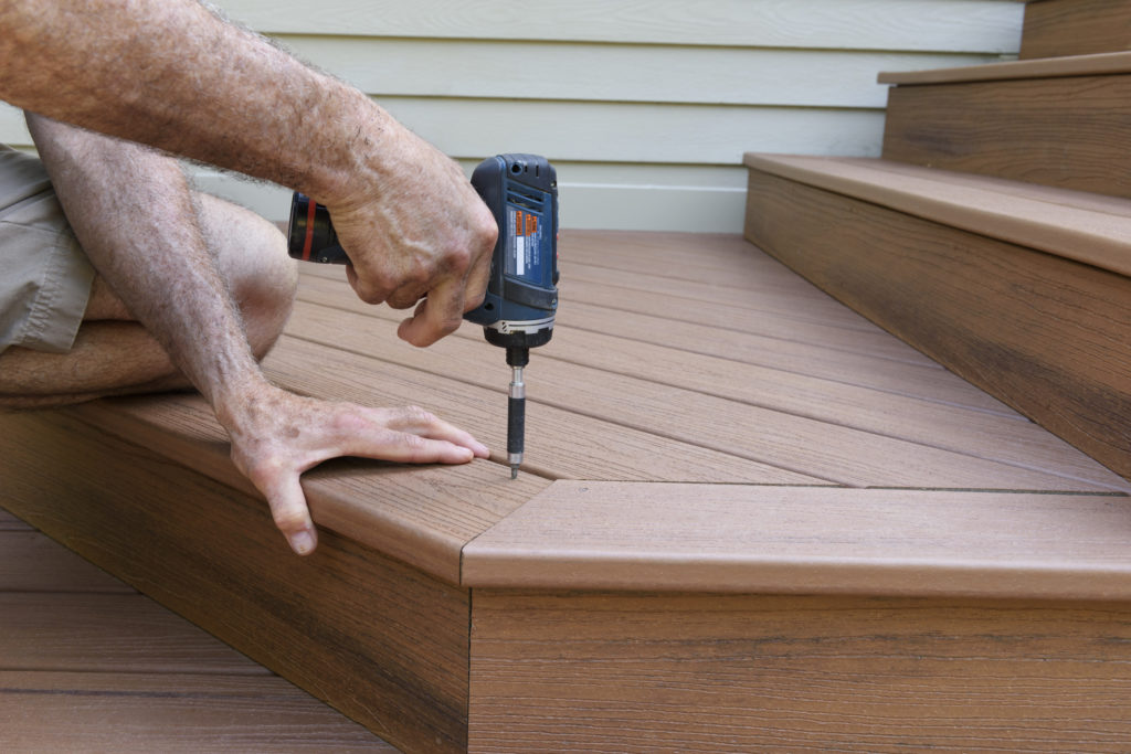 composite deck being installed by screwing it down